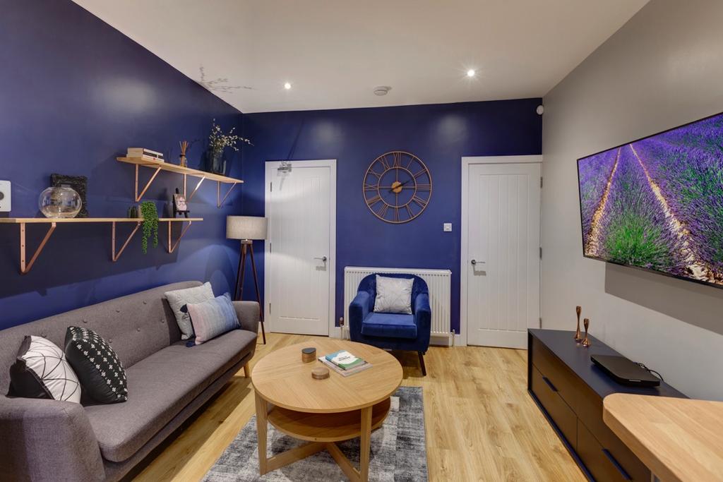 Stylish, modern living room with deep blue feat...