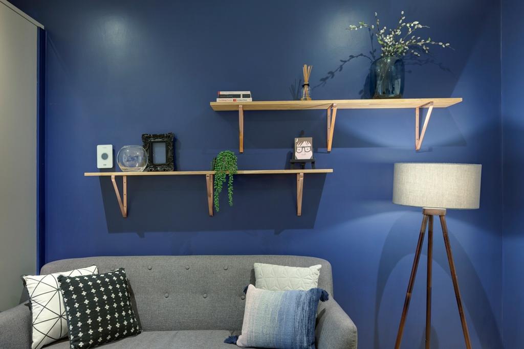 Stylish living area with a deep-blue feature wa...