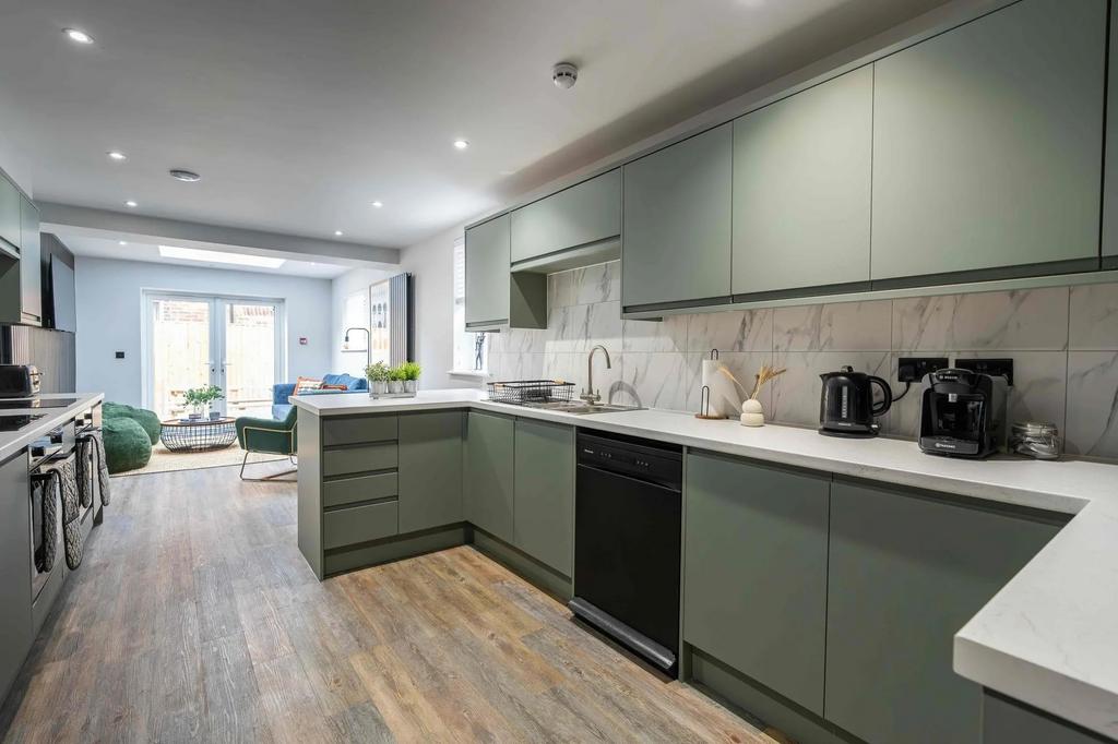 Modern kitchen with stylish sage green cabinets...