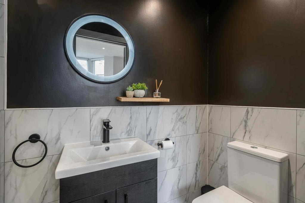 Modern bathroom featuring a sleek white sink wi...