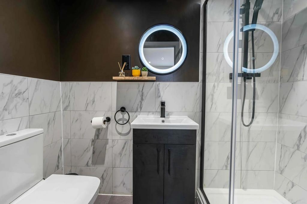 Modern bathroom featuring a sleek vanity, large...