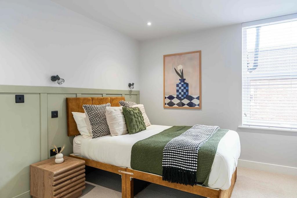 A stylish double bedroom featuring a wooden bed...