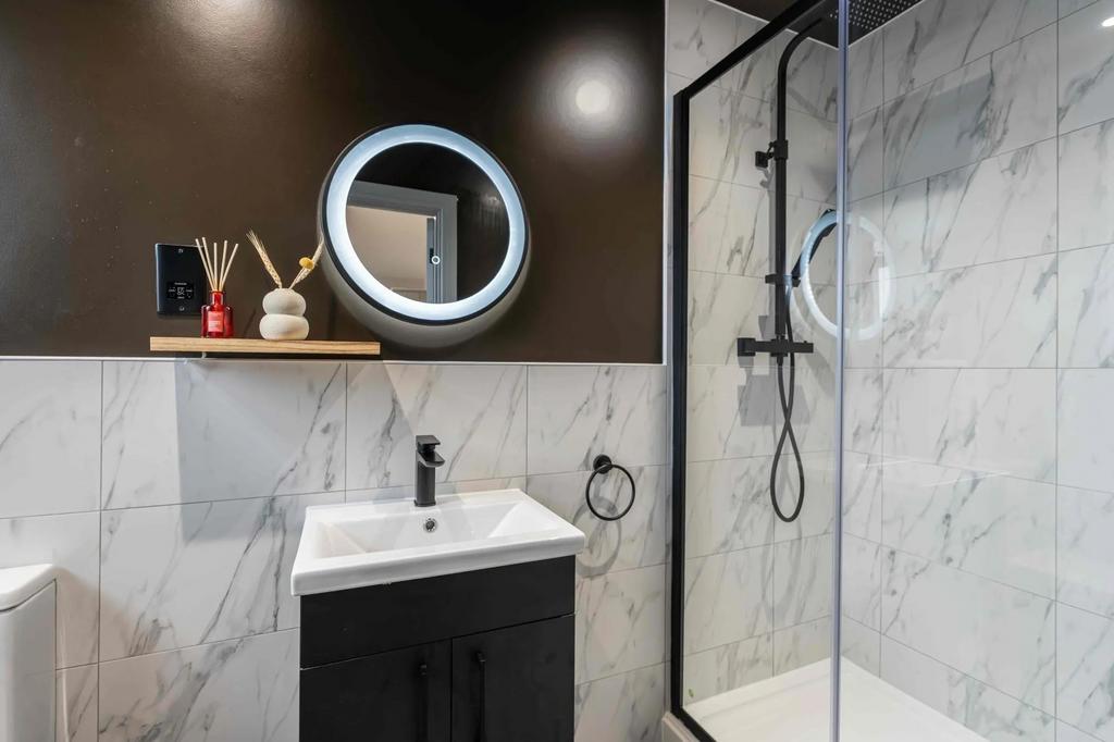 Modern bathroom featuring a sleek sink unit wit...