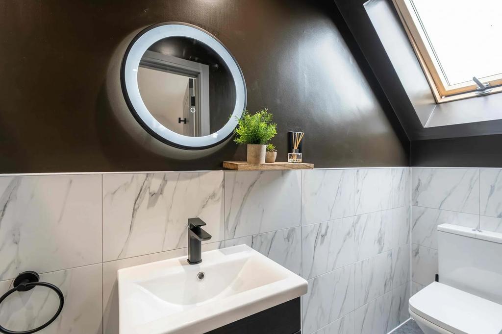Modern bathroom featuring a sleek white sink wi...