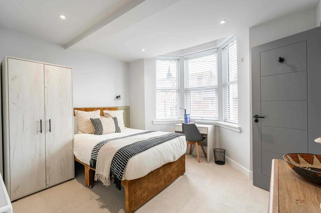 Bright and welcoming bedroom featuring a large ...