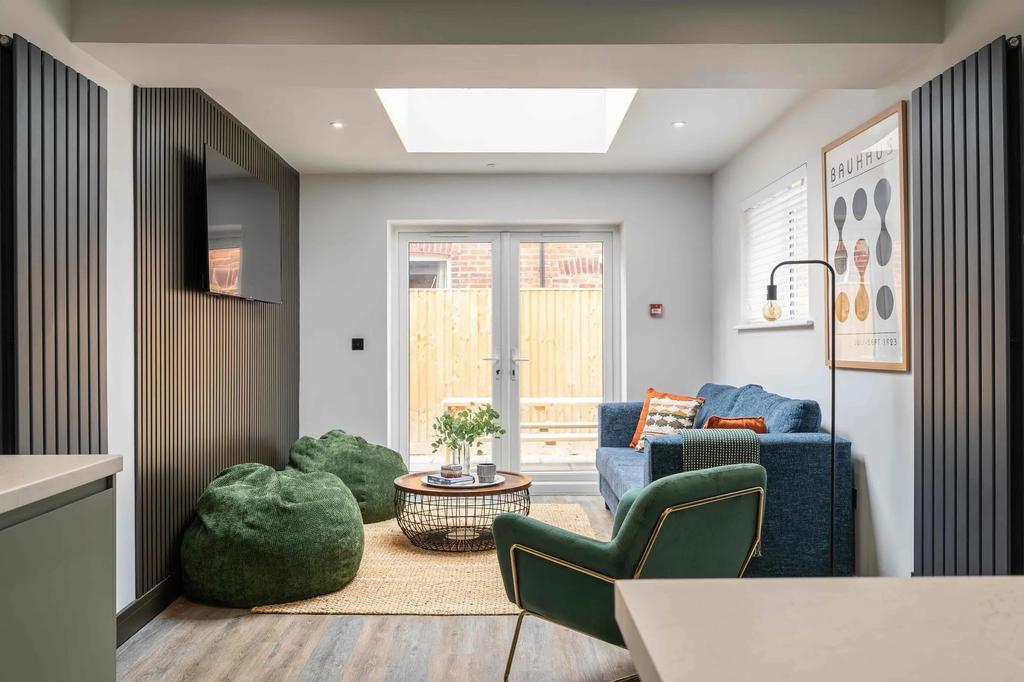 Modern and stylish living room featuring a comf...