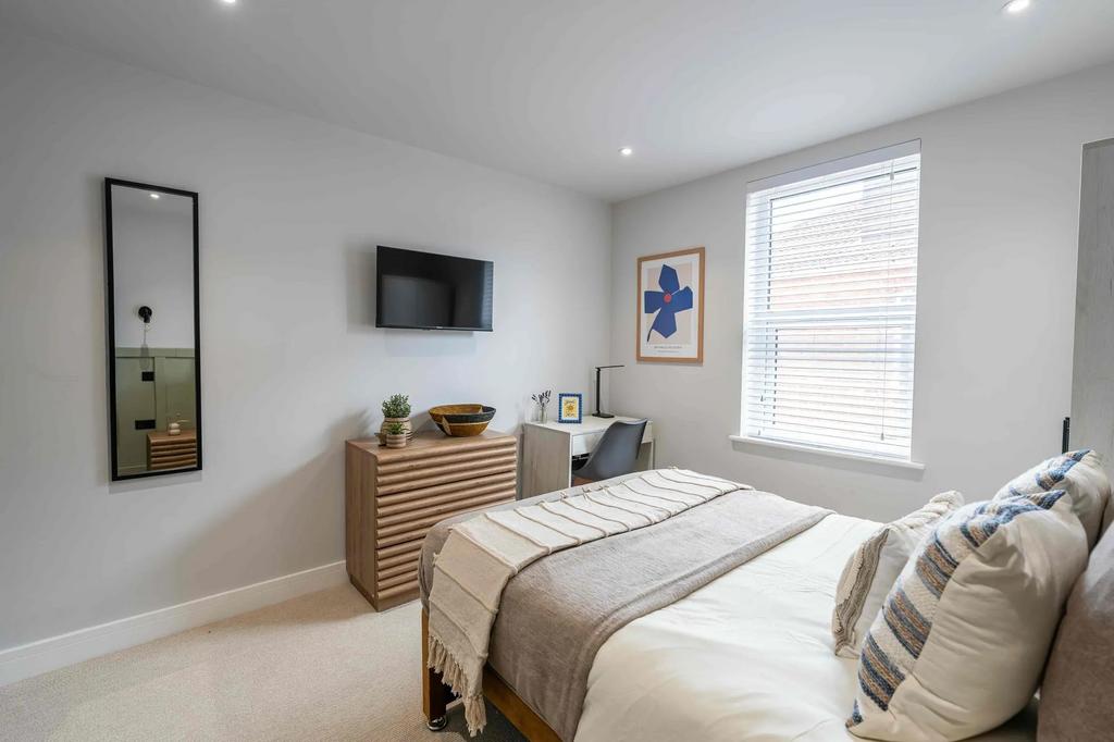 Bright and welcoming spacious bedroom featuring...