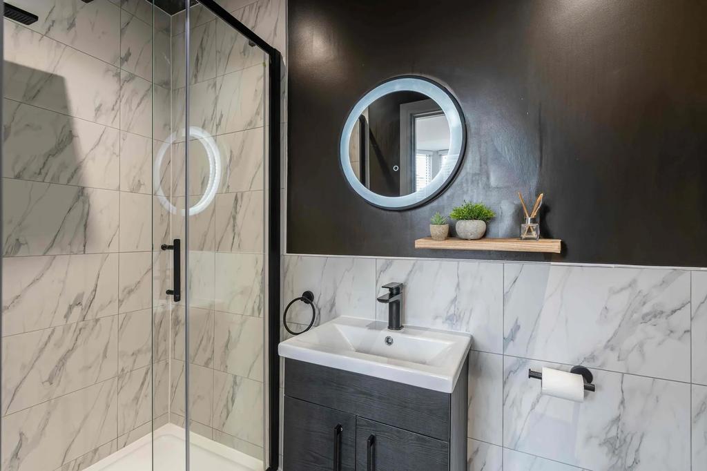Modern bathroom featuring a sleek walk-in showe...