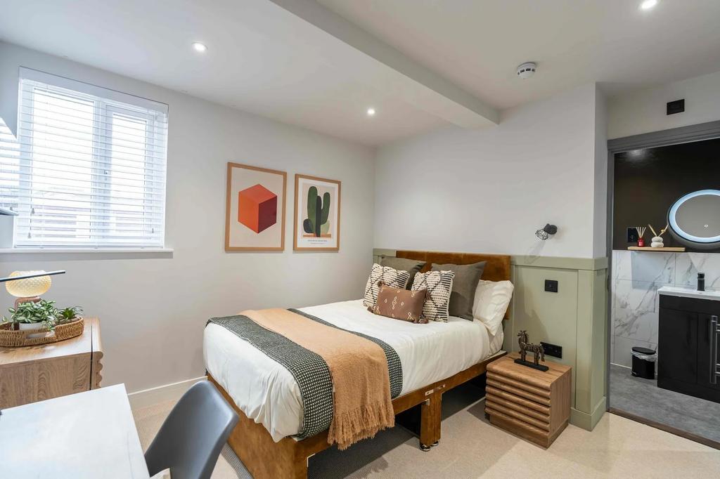 A well-lit, stylish double bedroom featuring a ...