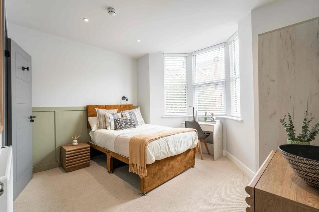Bright and inviting double bedroom with natural...