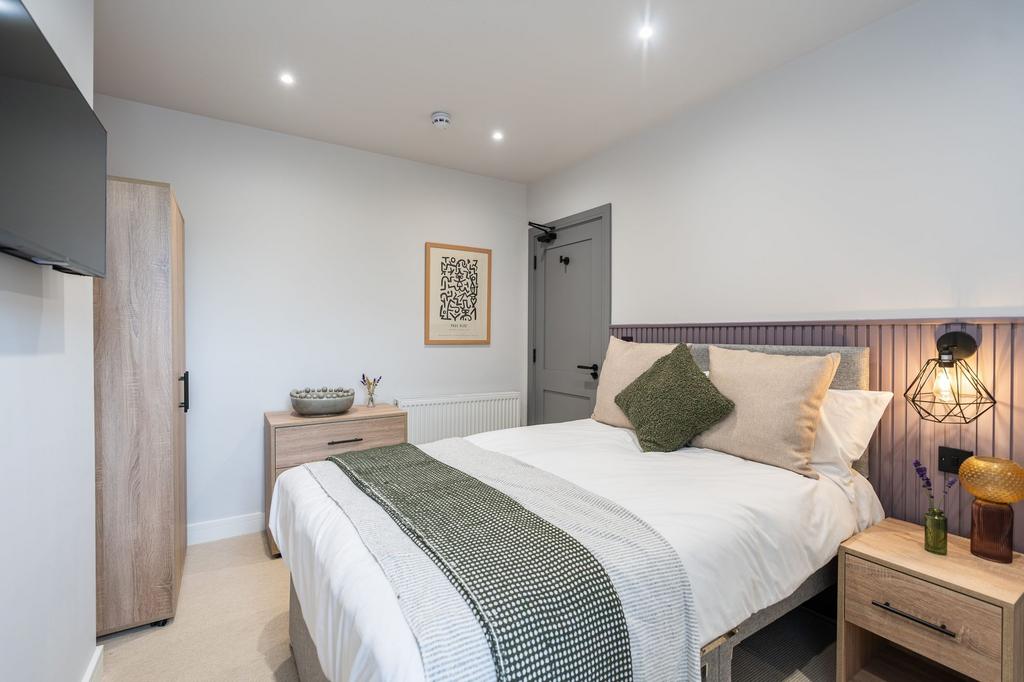 A modern, well-lit double bedroom featuring a c...
