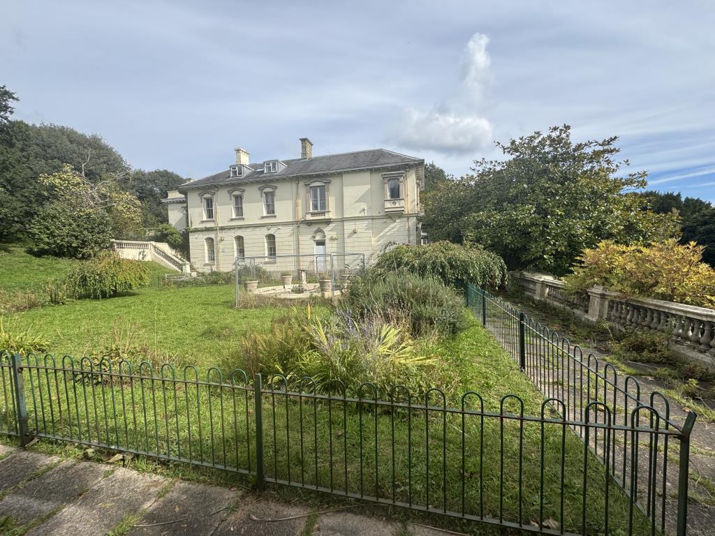 Side view of the property with gardens