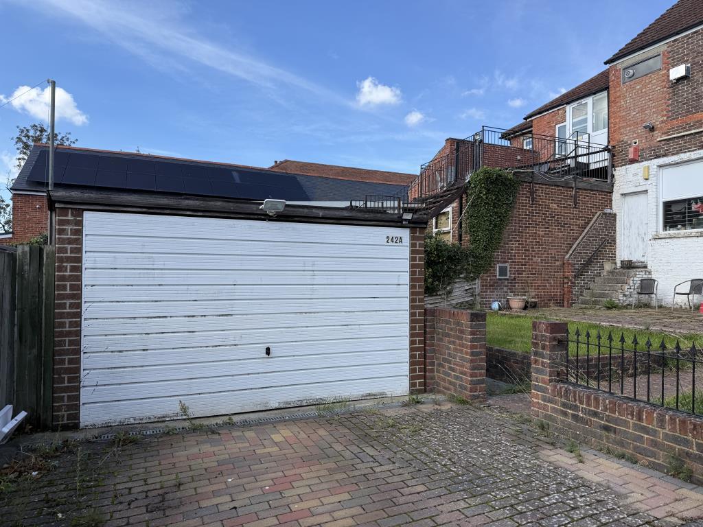 Garage with white up and over style door
