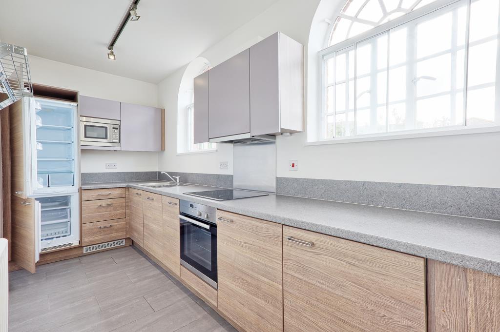 Kitchen with laminate flooring with bay window and