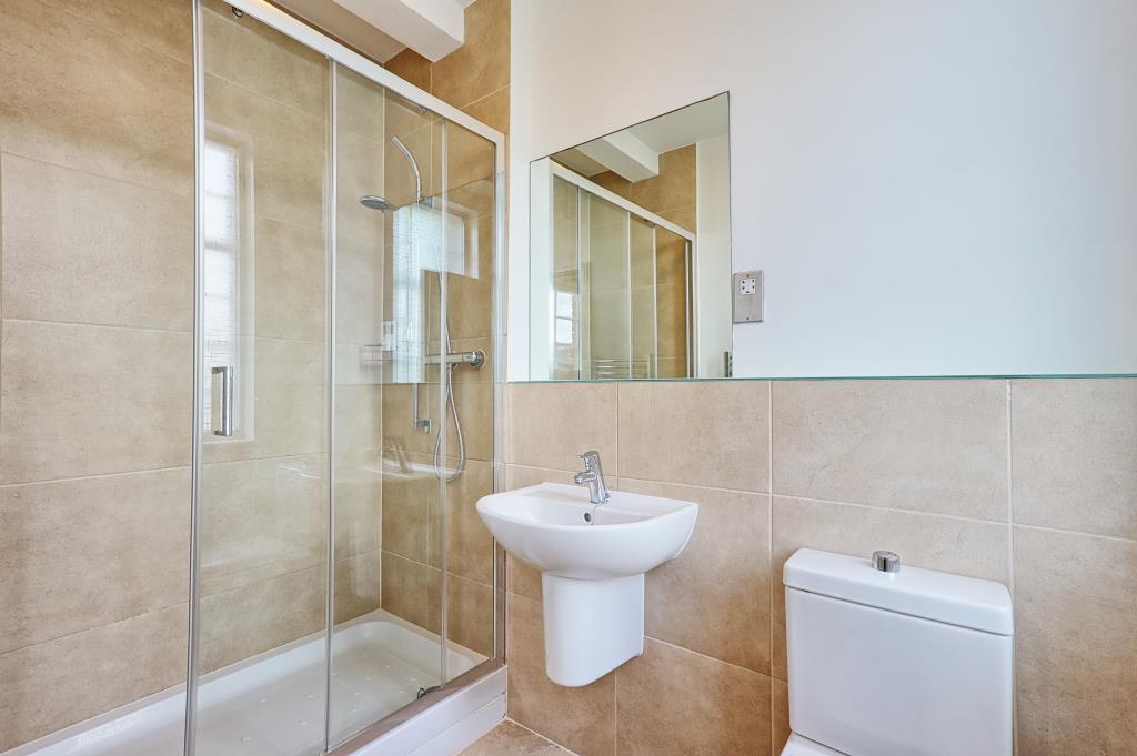 Tiled ensuite with double shower sink and toilet