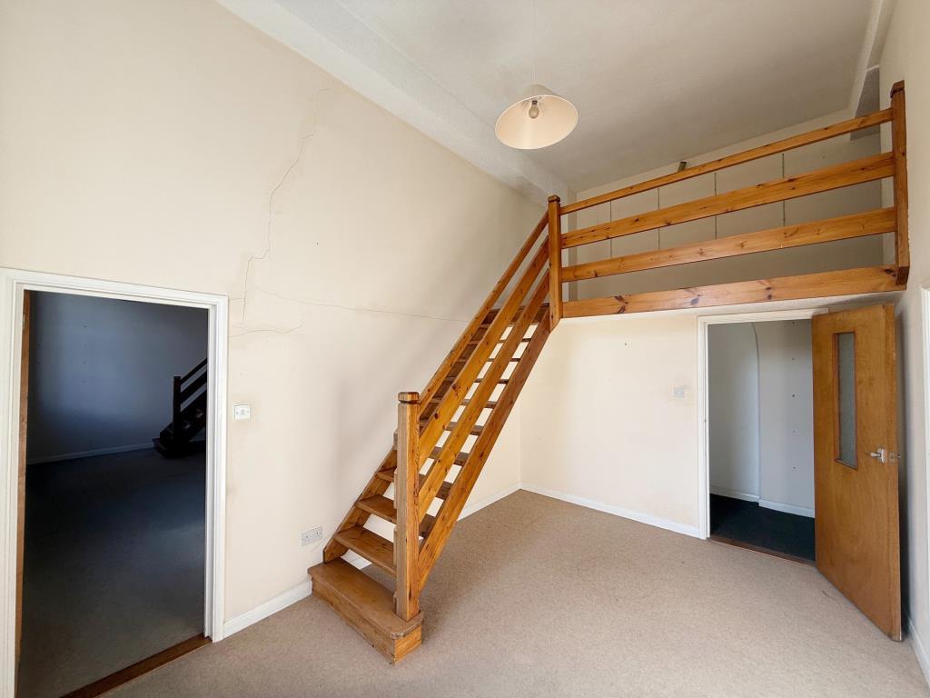 Office with stairs up to mezzanine level