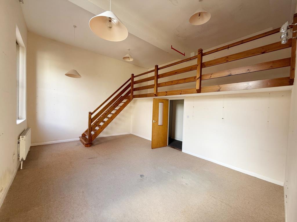 Larger office with raised level accessed via stair