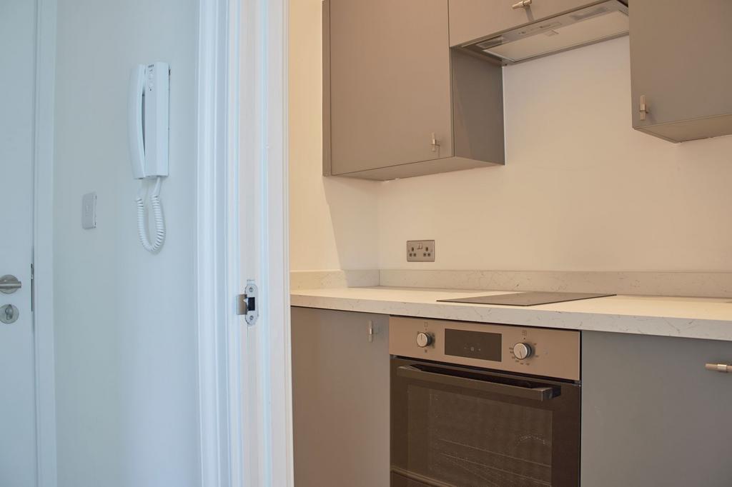 A modern kitchen featuring sleek grey cabinetry...