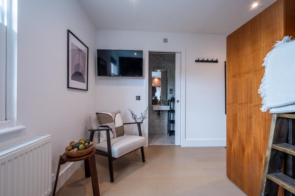 Bright and modern master bedroom featuring a st...