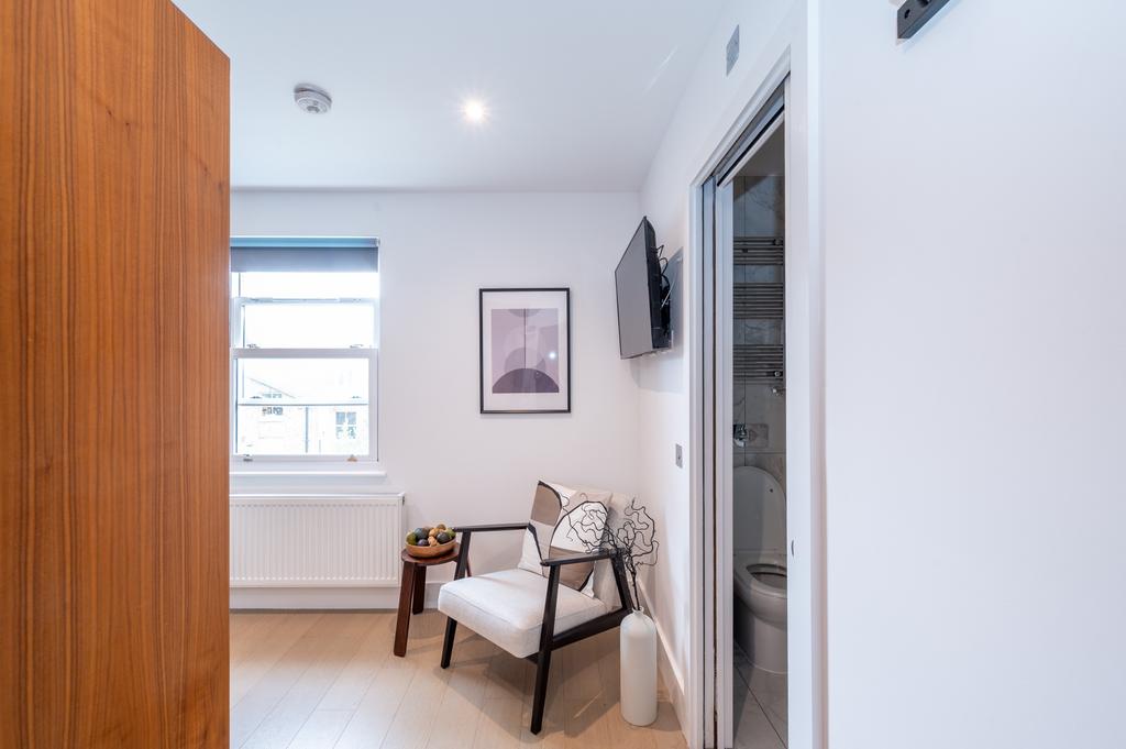 A modern, well-maintained room featuring a comf...