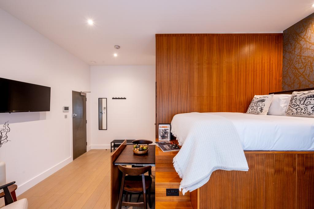 Bright and stylish studio bedroom featuring a r...