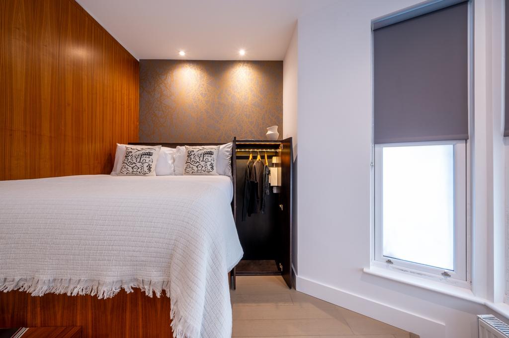 A stylish double bedroom featuring a neatly mad...