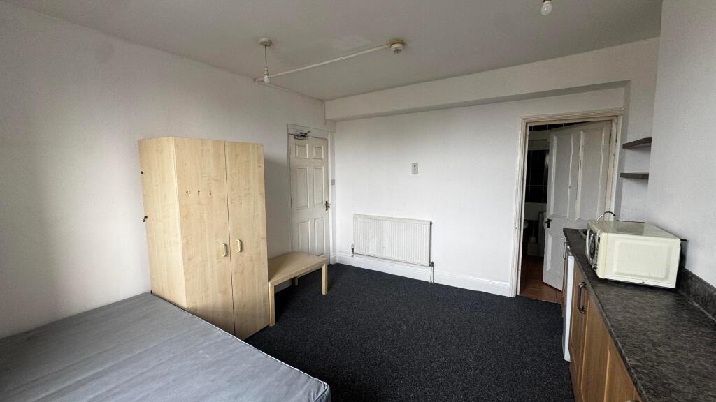 A simple, well-maintained bedroom featuring a b...
