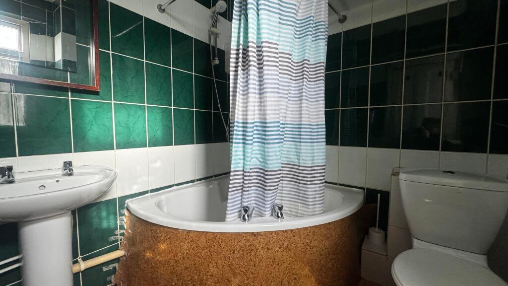 A clean and spacious bathroom featuring a class...