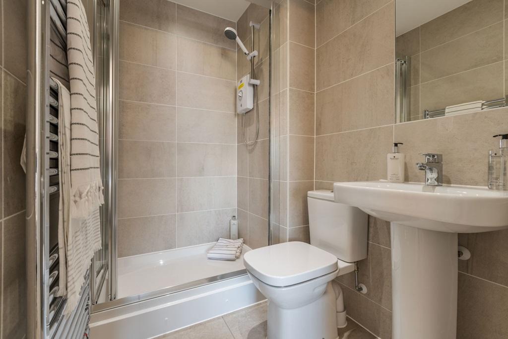 En suite with full width shower enclosure