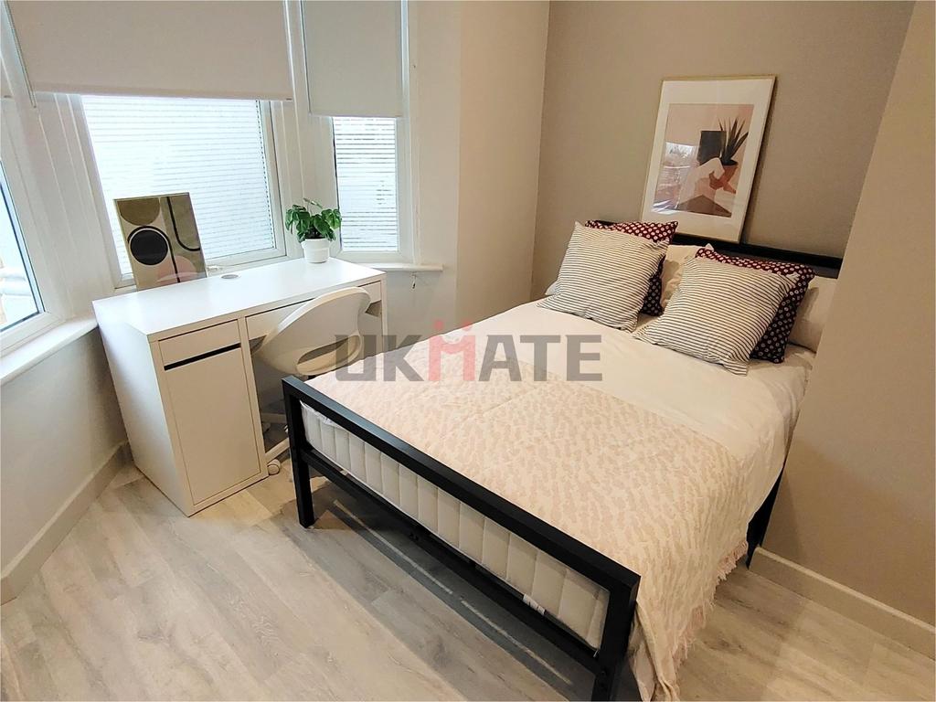 A bright and stylish double bedroom featuring a...