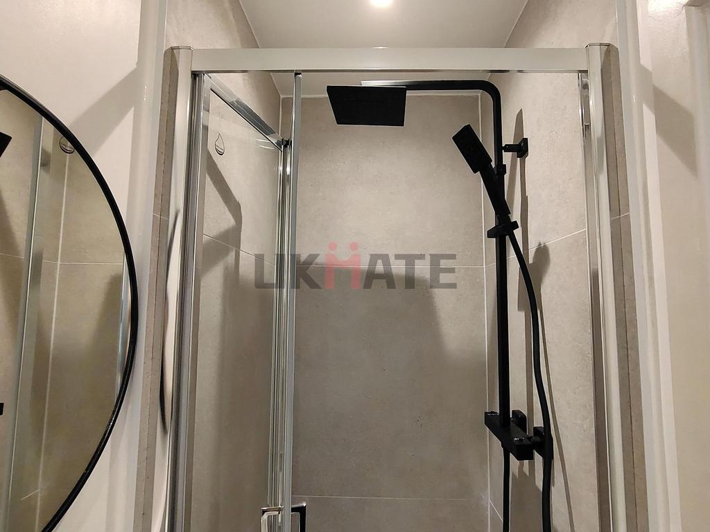 A modern bathroom featuring a walk-in shower wi...