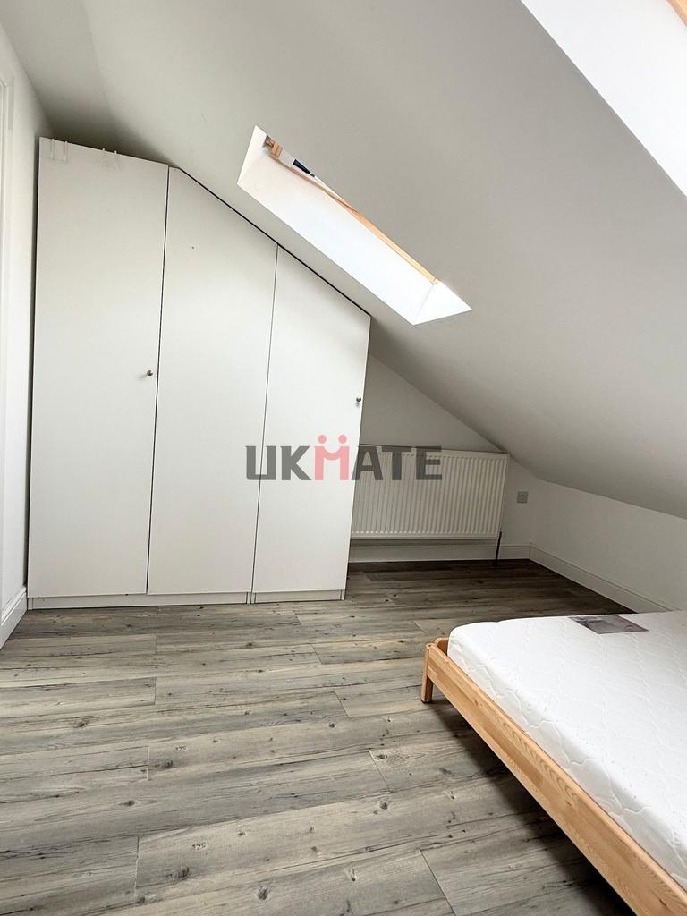 A bright and tidy bedroom featuring a white war...