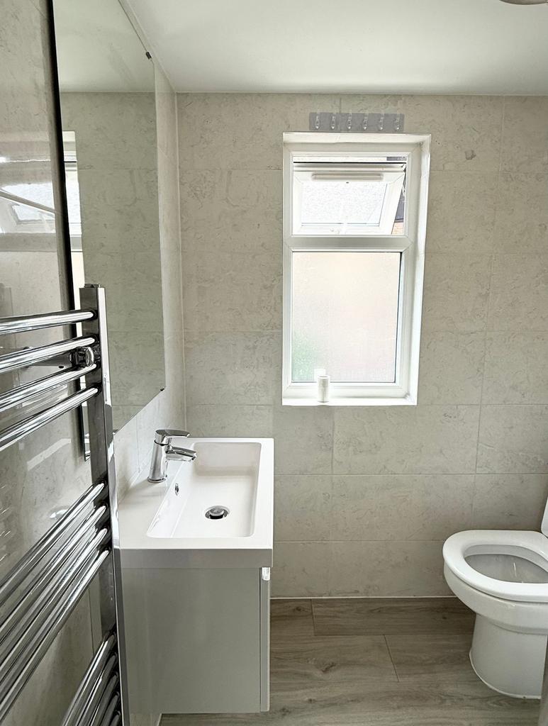 A bright and modern bathroom featuring a sleek ...
