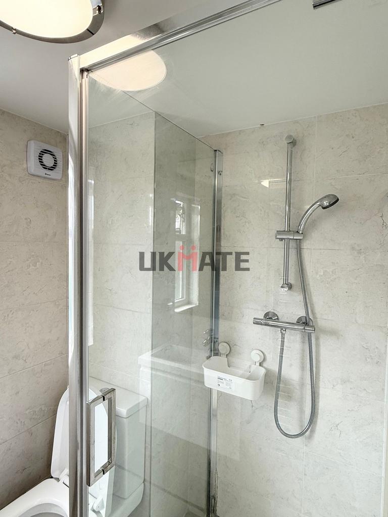 Modern and clean bathroom with a large shower a...