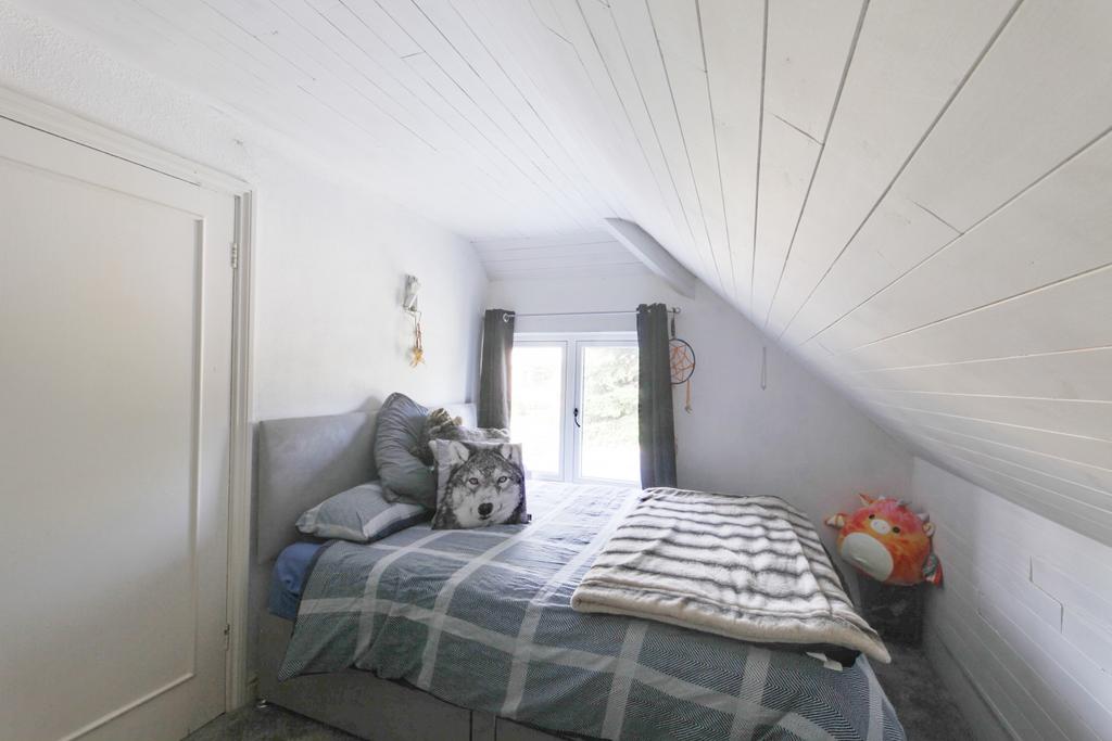 Facing rear of property with fitted wardrobes and