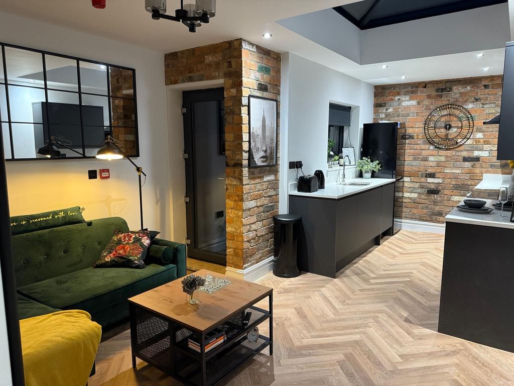 A stylish and modern living room featuring expo...
