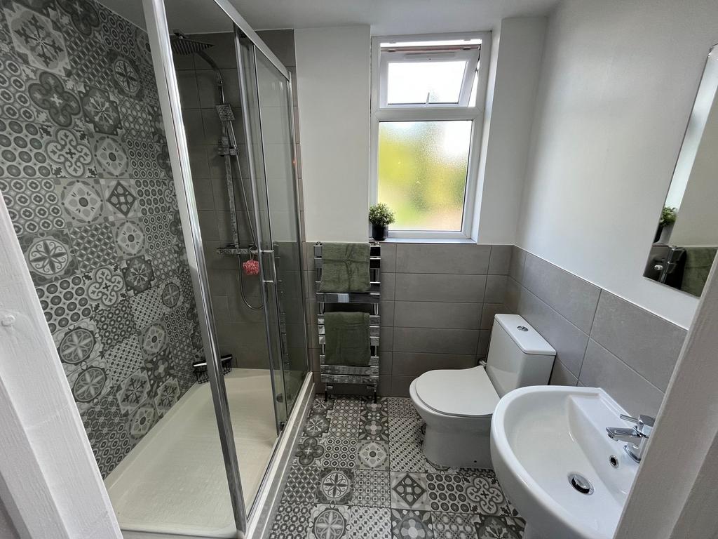 Bright and modern bathroom featuring patterned ...