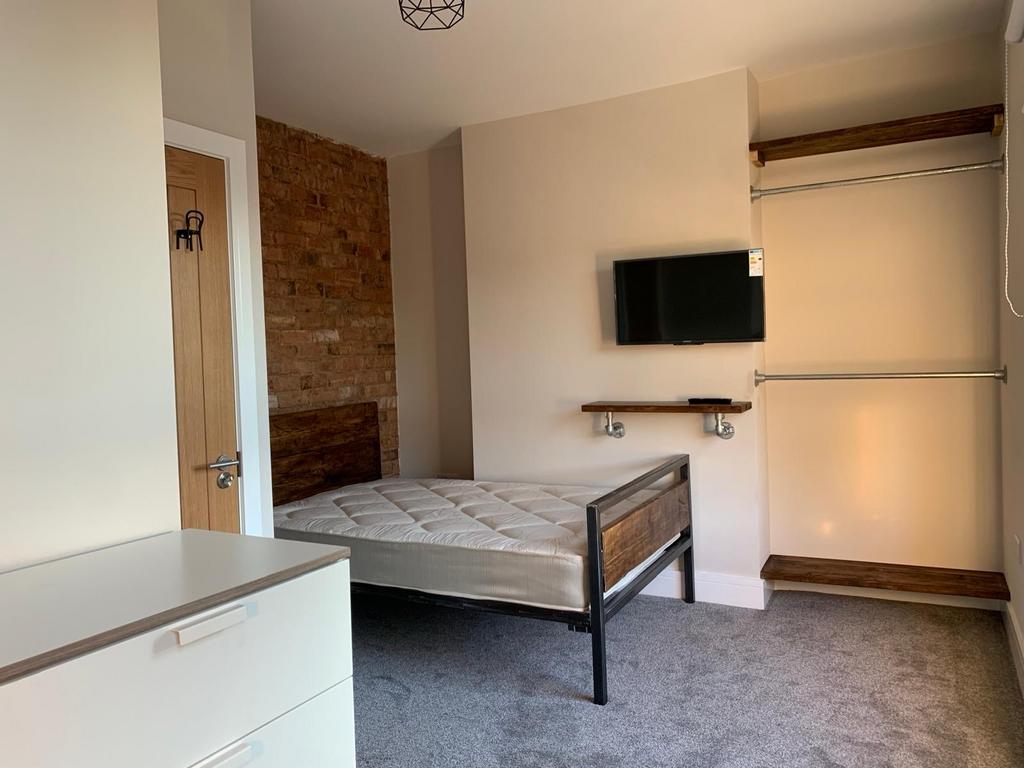 A cozy bedroom with a comfortable bed, a mounte...