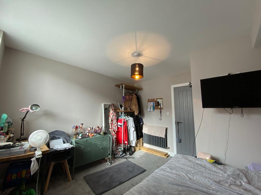 A cozy living room with various personal items,...