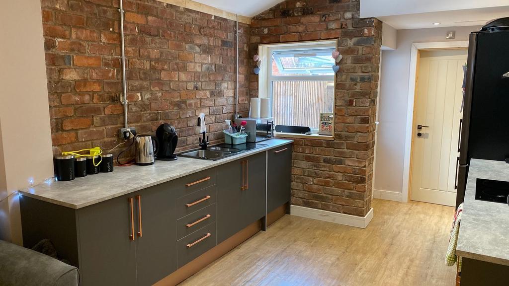 Modern kitchen featuring a sleek grey cabinetry...