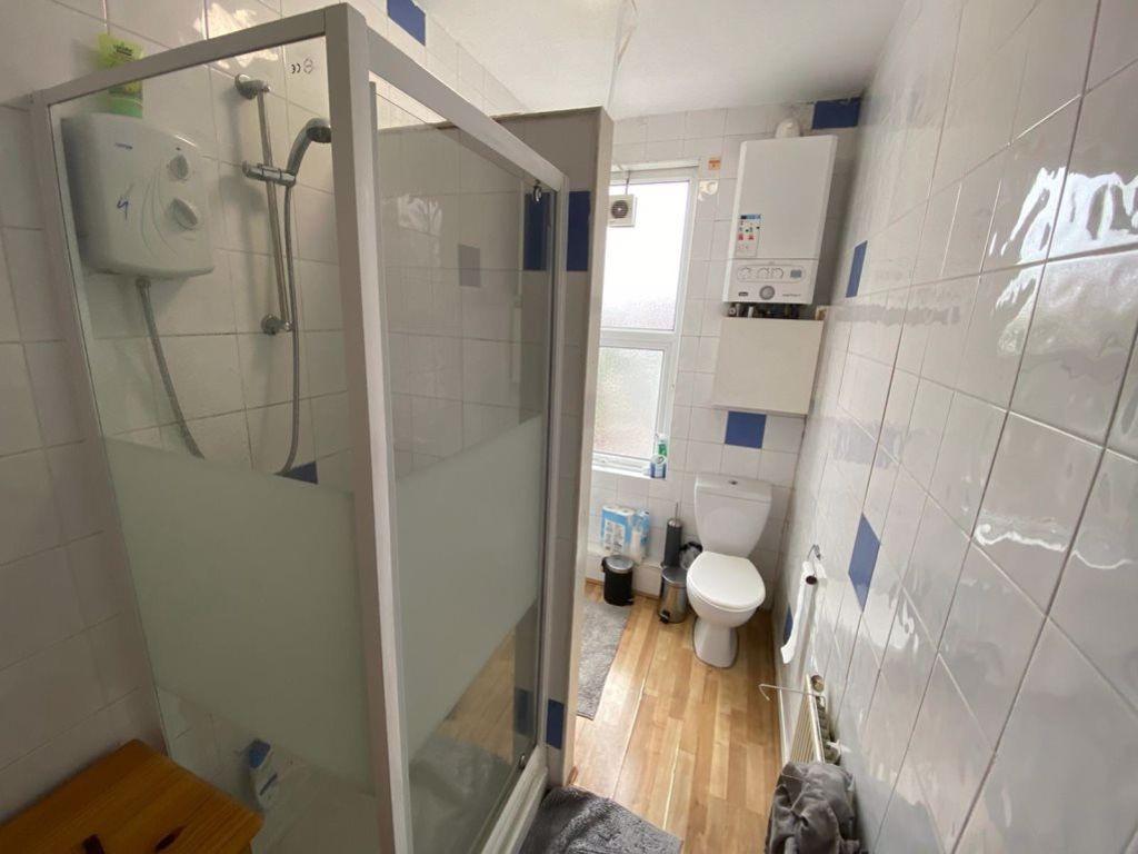 Bright and clean bathroom with a shower cabin a...