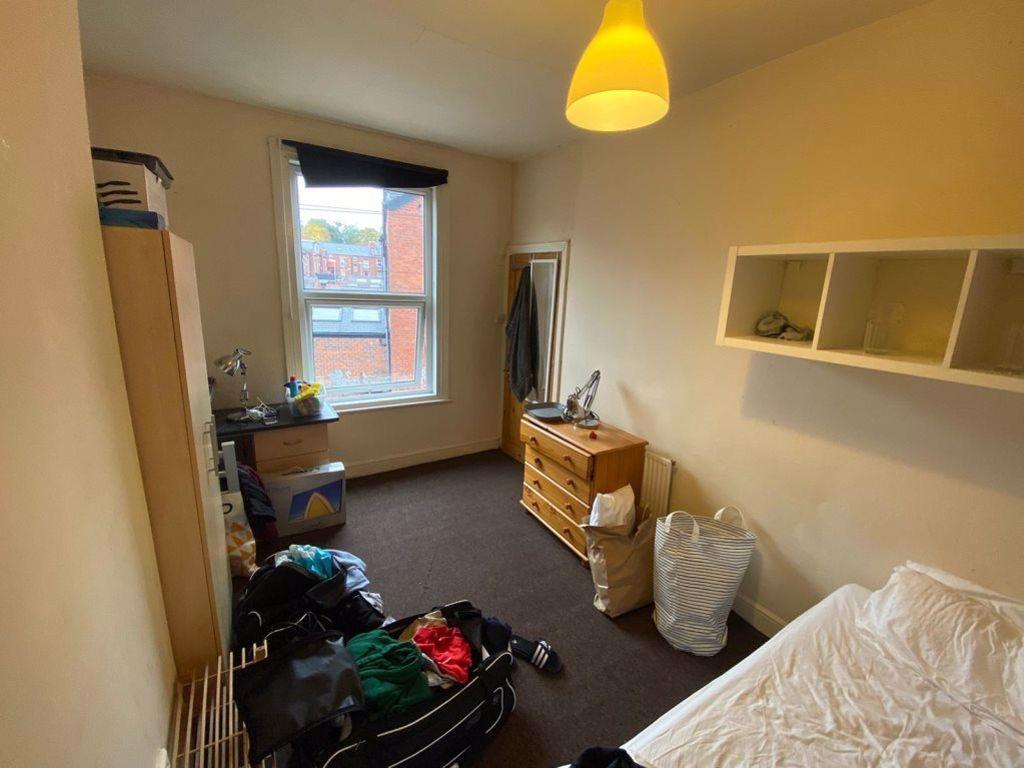 A cozy bedroom with a window bringing in natura...