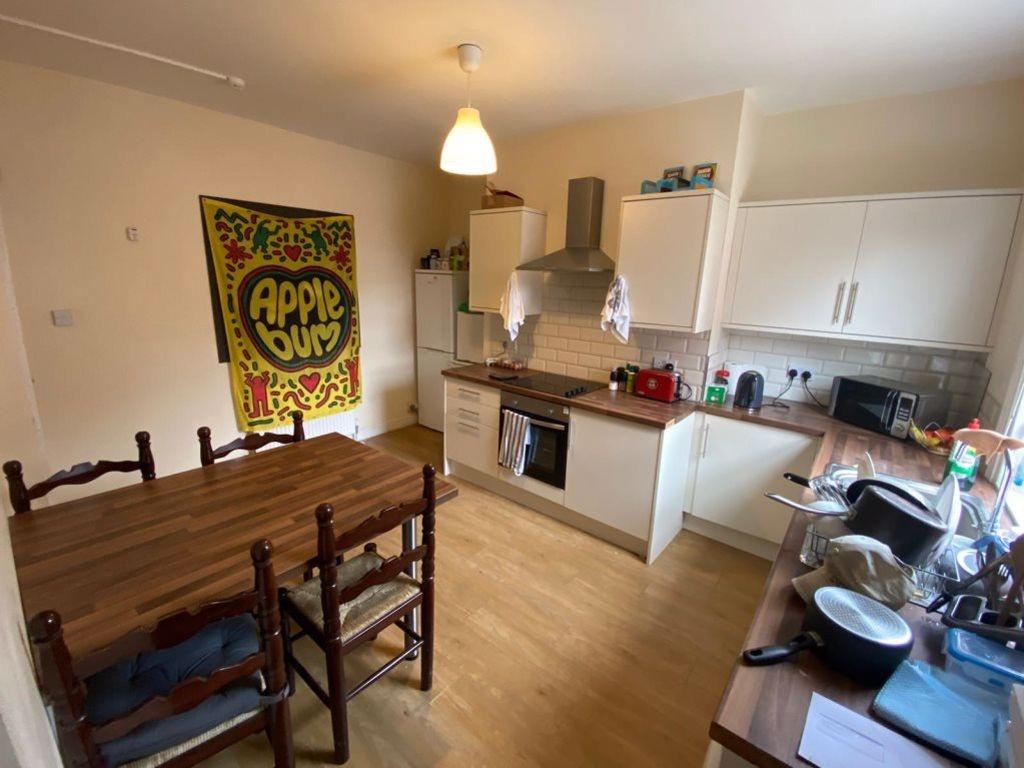 A well-lit and tidy kitchen area featuring whit...