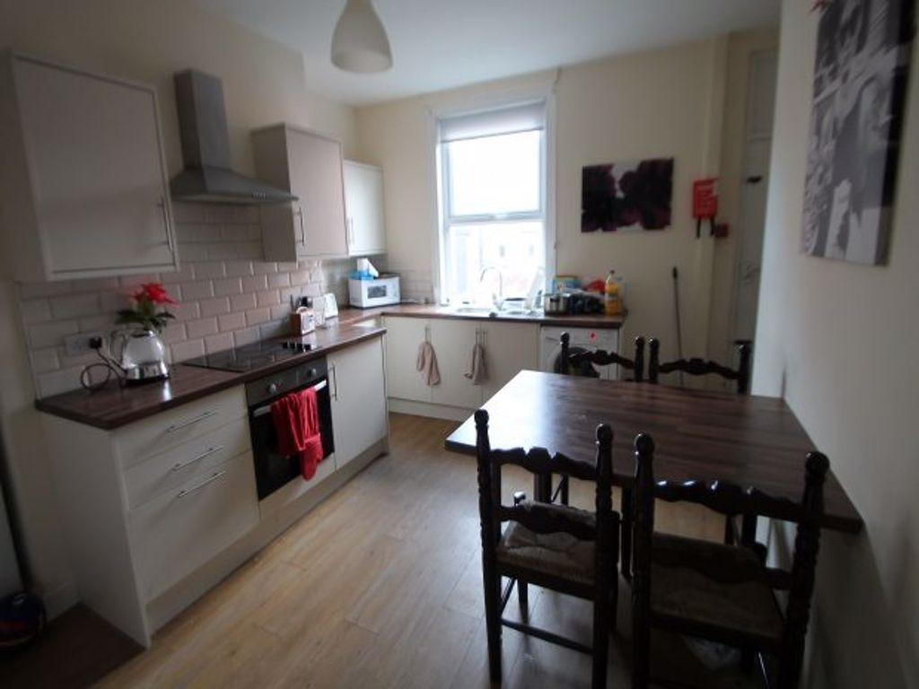 Bright and welcoming kitchen with ample natural...