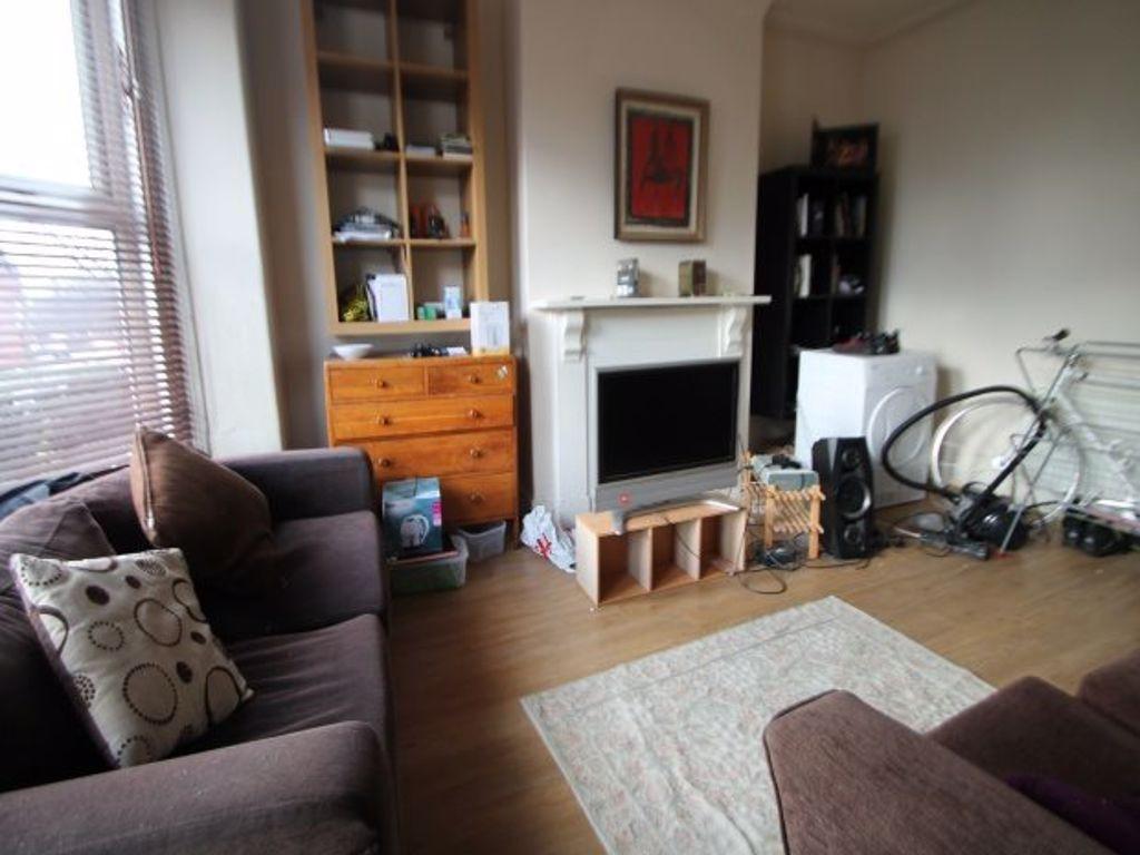 A spacious, well-lit living room featuring mode...