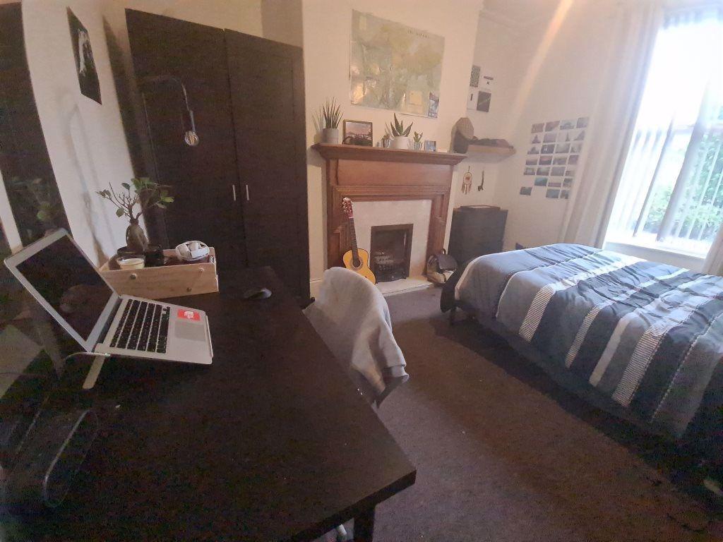 A cozy and well-maintained bedroom featuring a ...