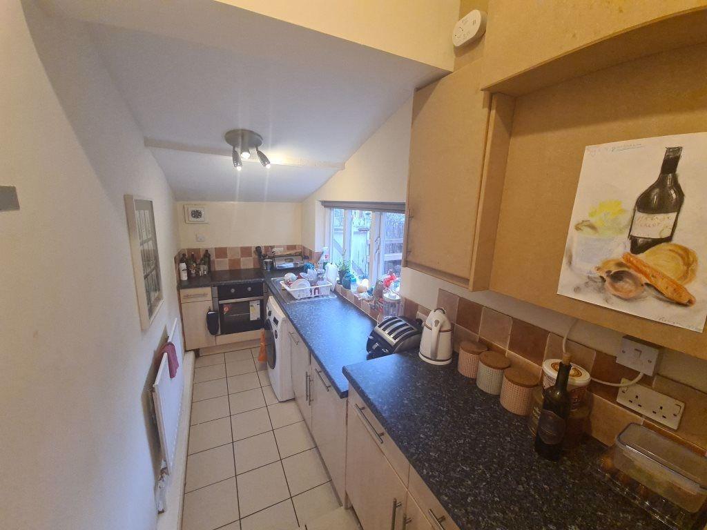 A well-lit kitchen area featuring a spacious co...