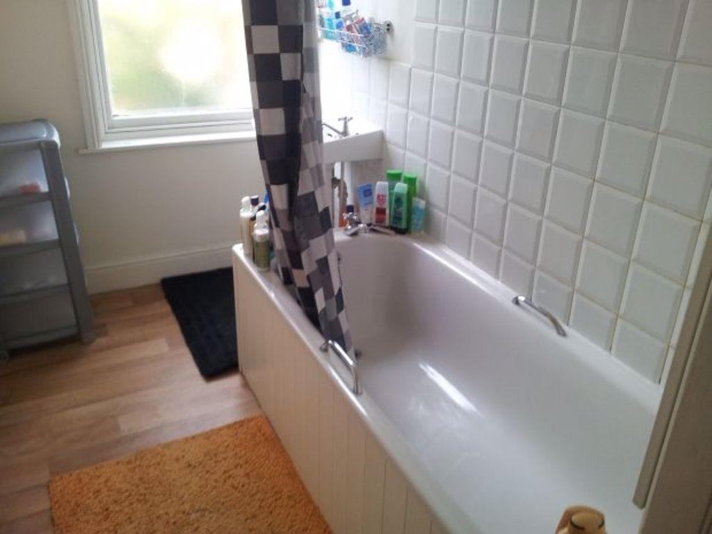 A clean, well-maintained bathroom with a bathtu...