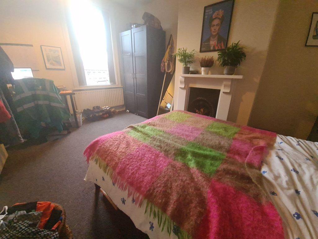 A cozy bedroom featuring a comfortable bed with...