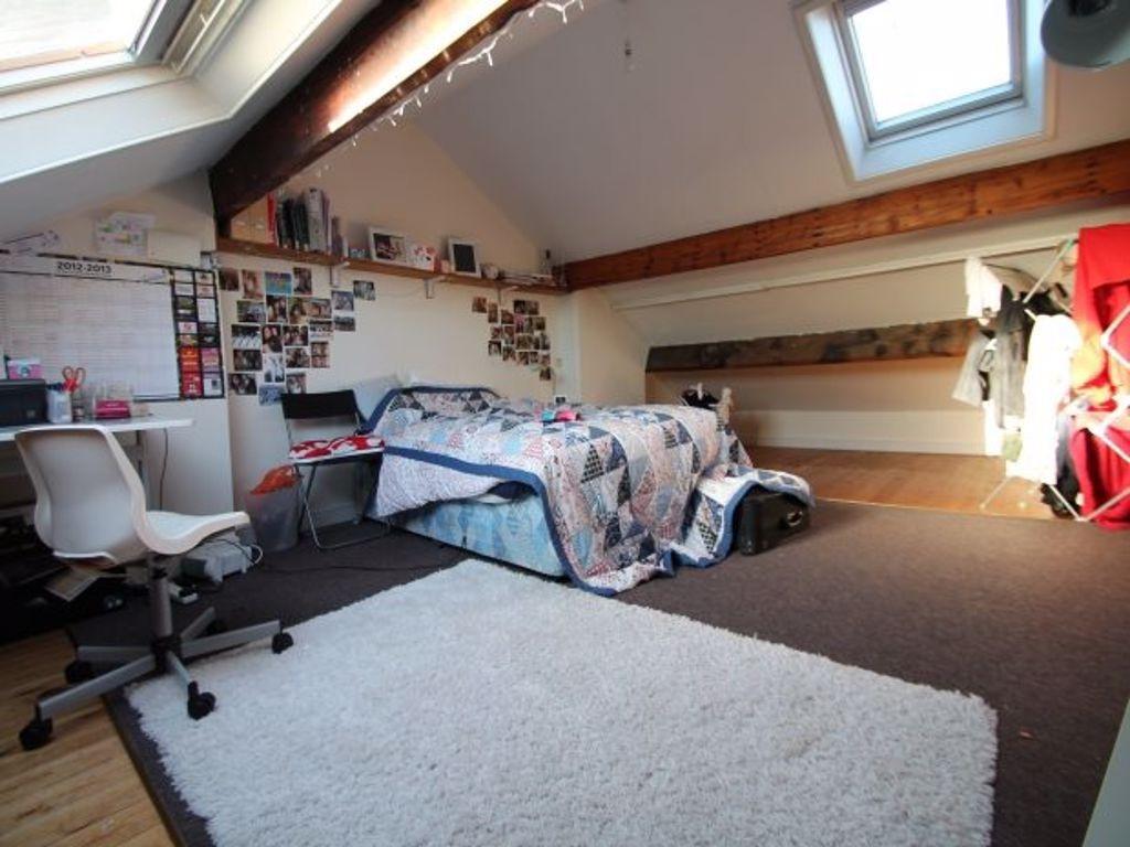 A spacious and well-lit master bedroom featurin...
